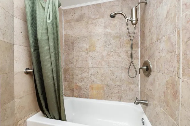 a bathroom with a shower and a bath tub