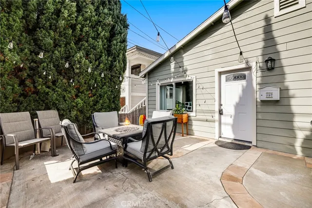 a view of a patio with table and chairs and wooden fence