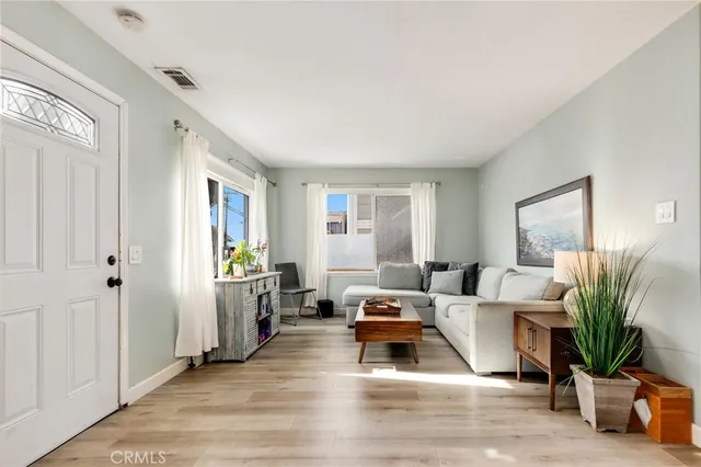 a living room with furniture rug and a window