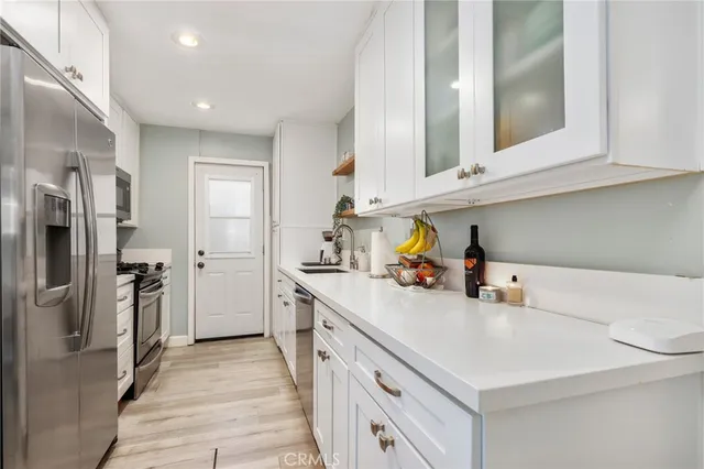 a kitchen with a sink cabinets and stainless steel appliances