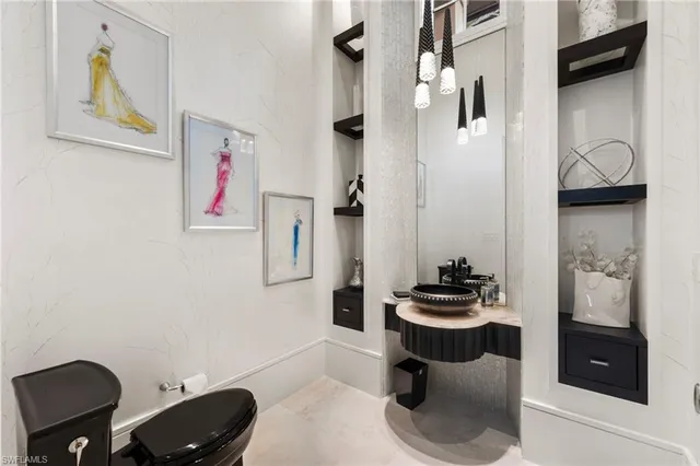 a living room with patio furniture and a flat screen tv