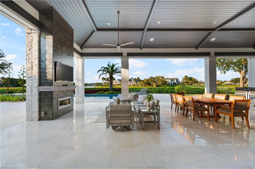 13851 Williston Way Naples, FL 34119 - Photo 30 of 50 a living room with patio furniture and a flat screen tv