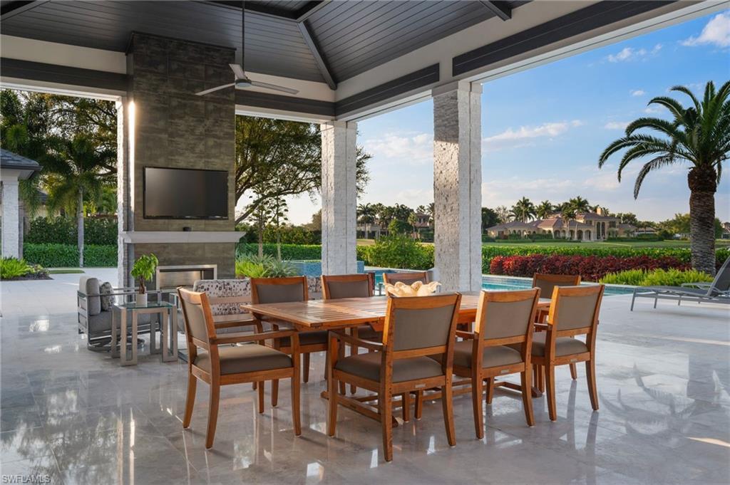 13851 Williston Way Naples, FL 34119 - Photo 34 of 50 a view of a patio with a dining table and chairs