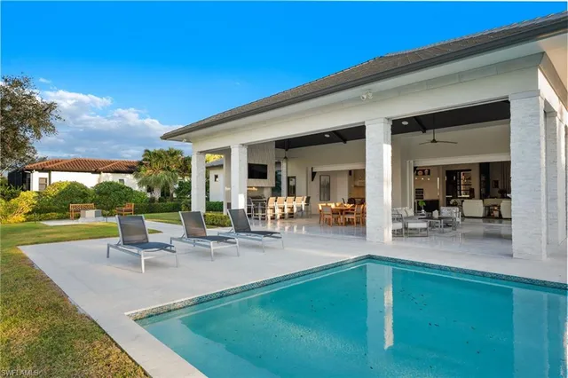 a view of swimming pool with a table and chairs