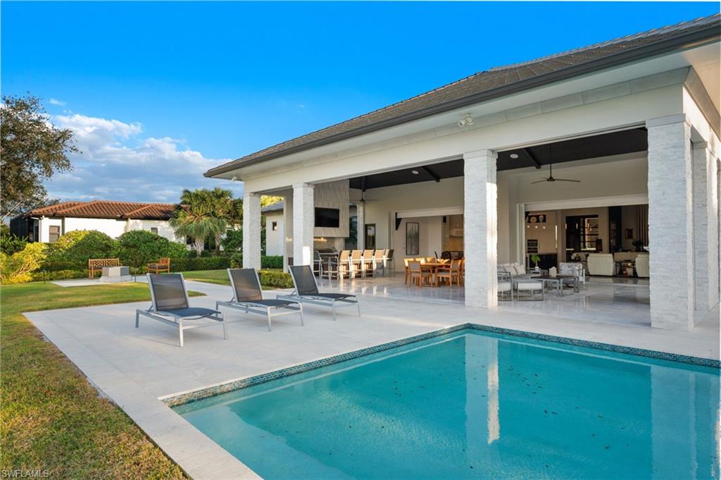 13851 Williston Way Naples, FL 34119 - Photo 39 of 50 a view of a backyard with a patio and fire pit