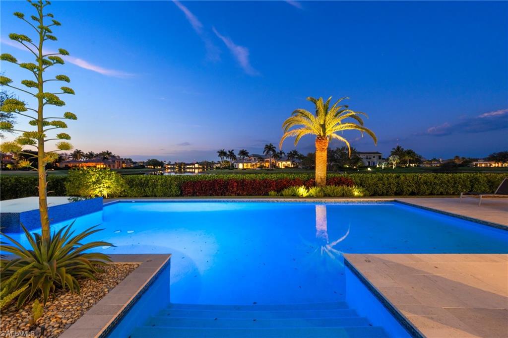 13851 Williston Way Naples, FL 34119 - Photo 40 of 50 a view of swimming pool with a table and chairs