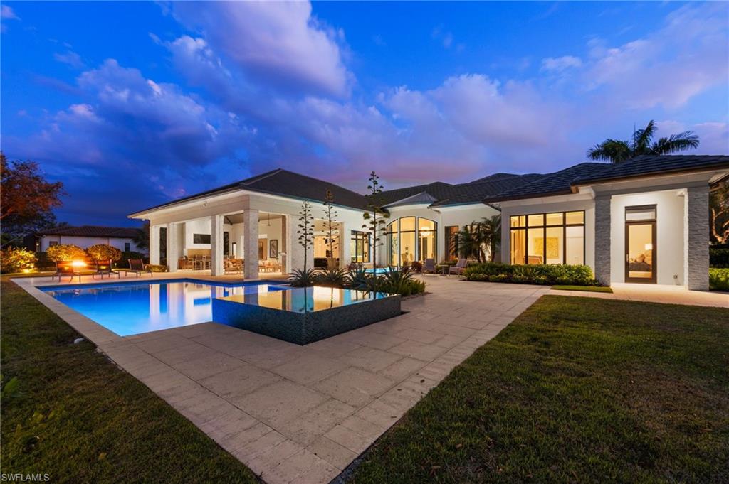 13851 Williston Way Naples, FL 34119 - Photo 41 of 50 a front view of a house with swimming pool
