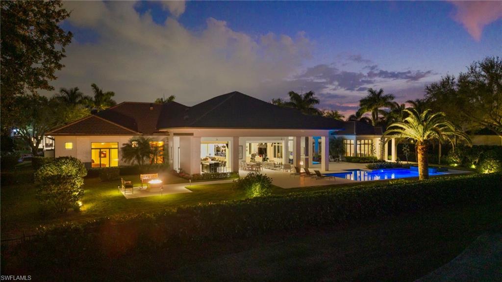 13851 Williston Way Naples, FL 34119 - Photo 48 of 50 a front view of a house with a garden