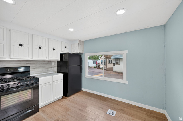 200 North Harrisville Road, Unit 37 Ogden, UT 84404 - Photo 10 of 14 Kitchen featuring black appliances, white cabinetry, light wood finished floors, tasteful backsplash, and recessed lighting