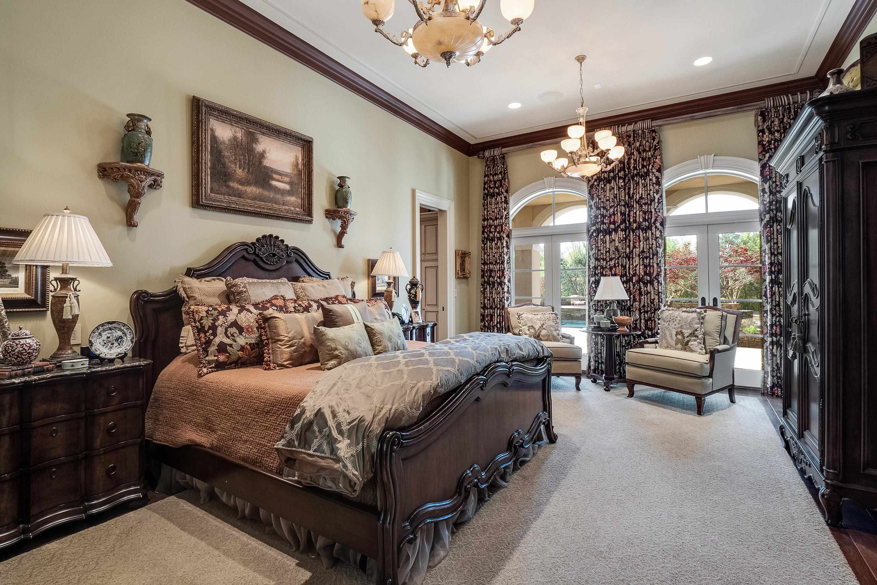 2000 Patrick Drive Corinth, MS 38834 - Photo 12 of 25 a bedroom with a large bed and a chandelier