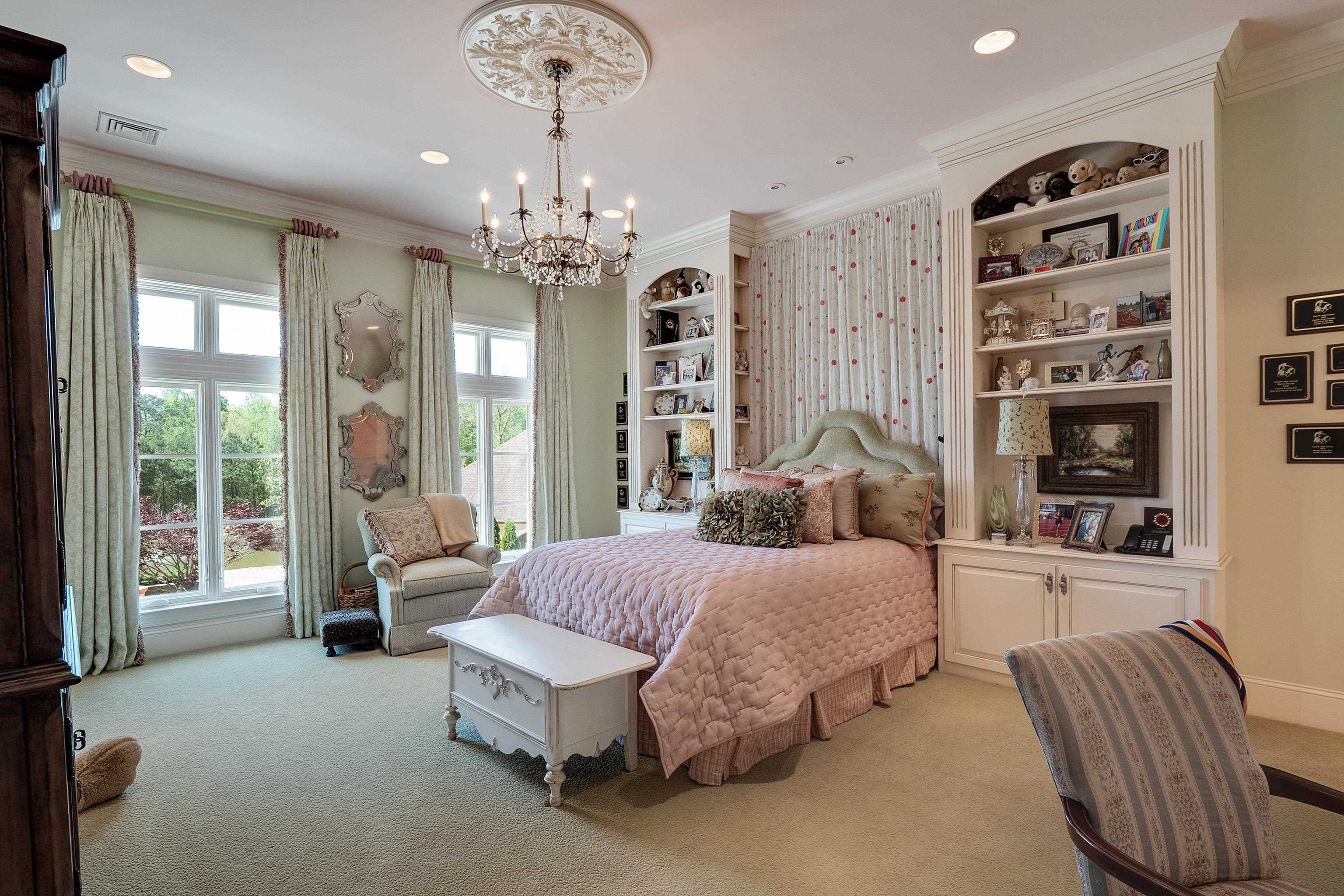 2000 Patrick Drive Corinth, MS 38834 - Photo 19 of 25 a spacious bedroom with a bed and a chandelier