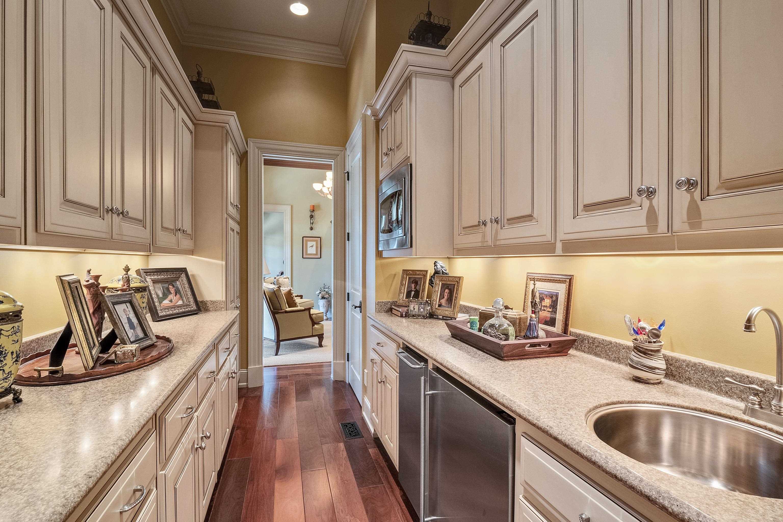 2000 Patrick Drive Corinth, MS 38834 - Photo 7 of 25 a kitchen with granite countertop a sink dishwasher stove and cabinets