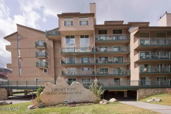 a front view of a residential apartment building with a yard