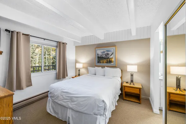 a bedroom with a bed and a window