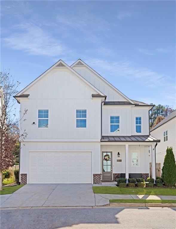 1859 Commons Place Atlanta, GA 30318 - Photo 1 of 53 a view of a white house with a yard and plants