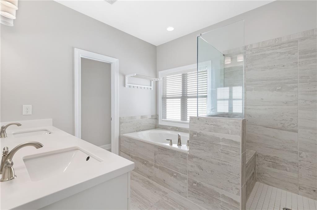1859 Commons Place Atlanta, GA 30318 - Photo 25 of 53 a bathroom with a bathtub sink and mirror