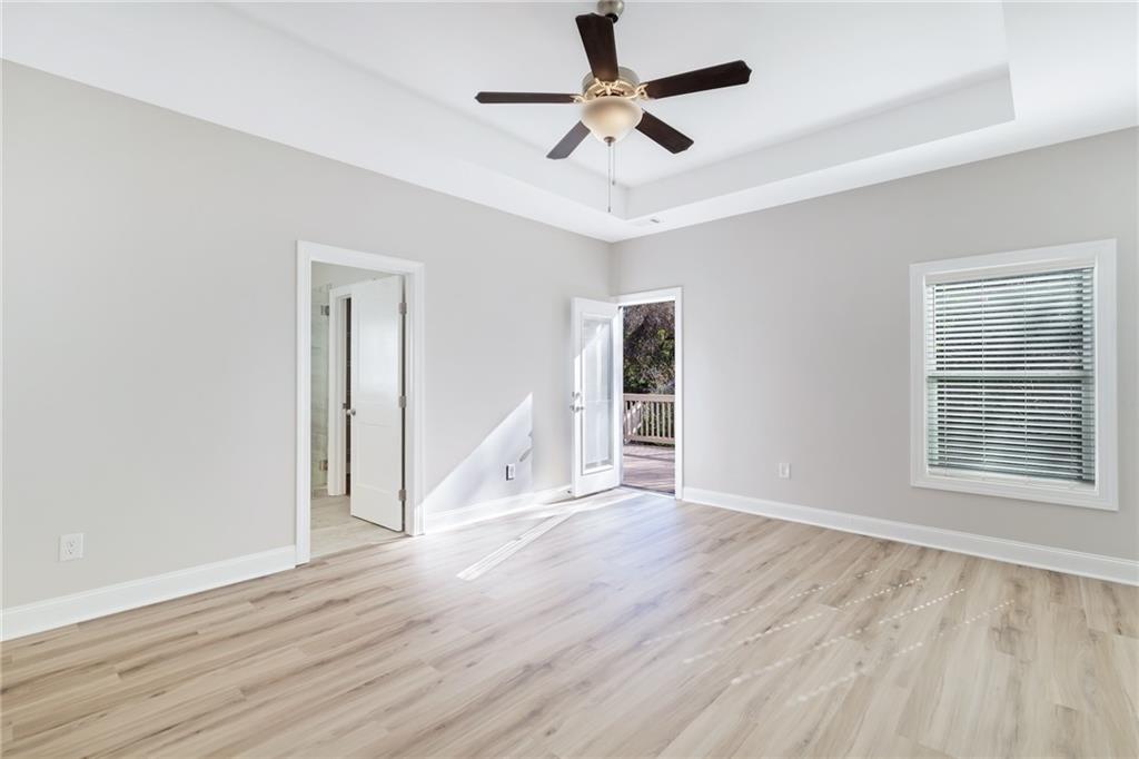 1859 Commons Place Atlanta, GA 30318 - Photo 30 of 53 a view of an empty room with wooden floor and a ceiling fan