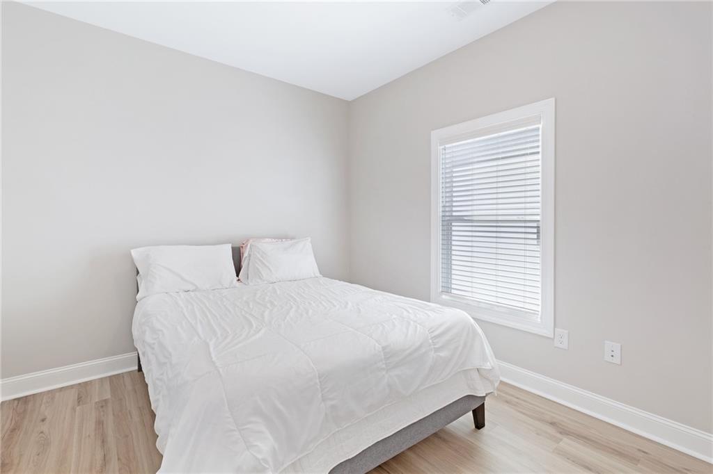 1859 Commons Place Atlanta, GA 30318 - Photo 34 of 53 a large bed sitting in a bedroom next to a window