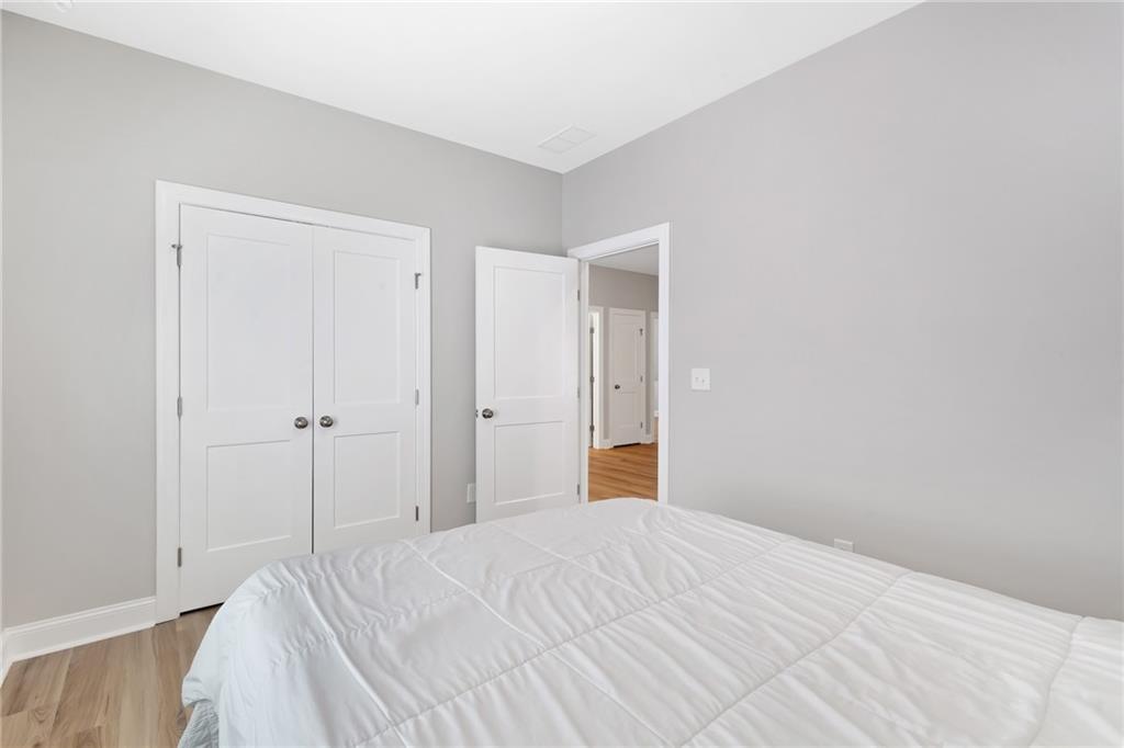 1859 Commons Place Atlanta, GA 30318 - Photo 35 of 53 a view of a room with a bed and wooden floor