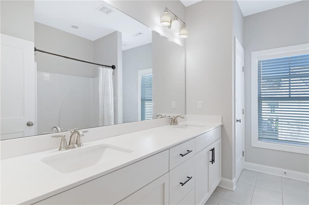 1859 Commons Place Atlanta, GA 30318 - Photo 37 of 53 a bathroom with a sink and a mirror