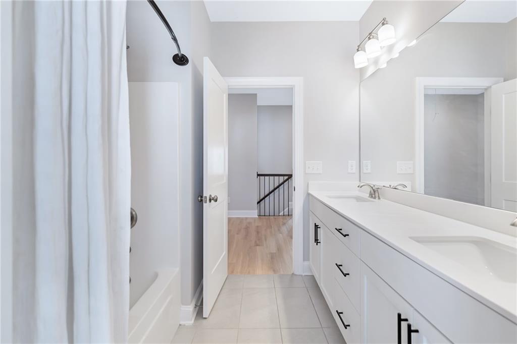 1859 Commons Place Atlanta, GA 30318 - Photo 38 of 53 a bathroom with a double vanity sink and a mirror