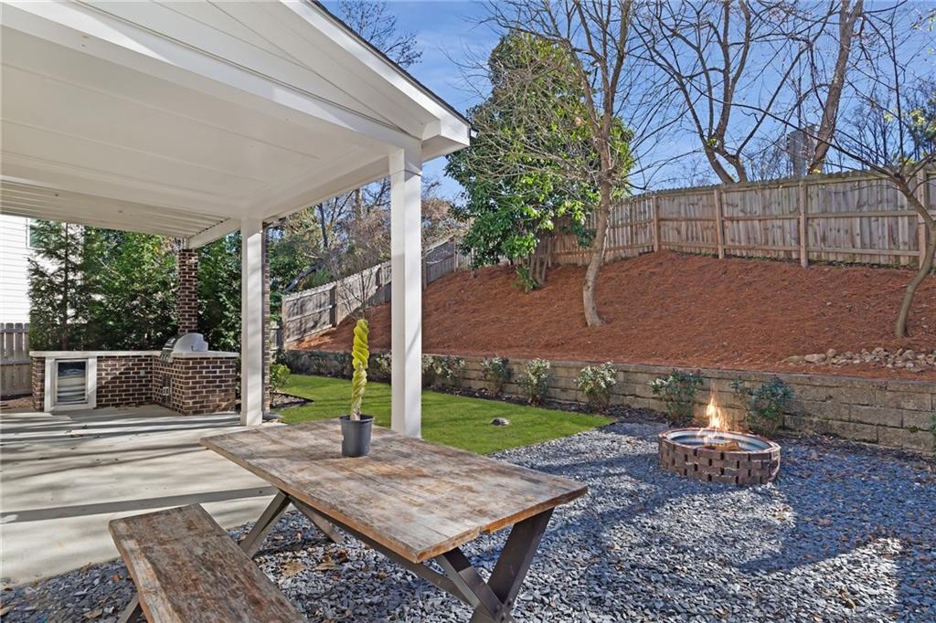 1859 Commons Place Atlanta, GA 30318 - Photo 42 of 53 a view of a patio with table and chairs potted plants and floor to ceiling window