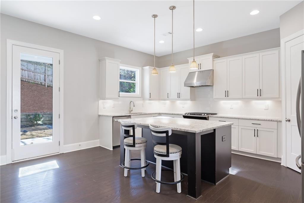 1859 Commons Place Atlanta, GA 30318 - Photo 5 of 53 a kitchen with a stove a sink a dining table and chairs