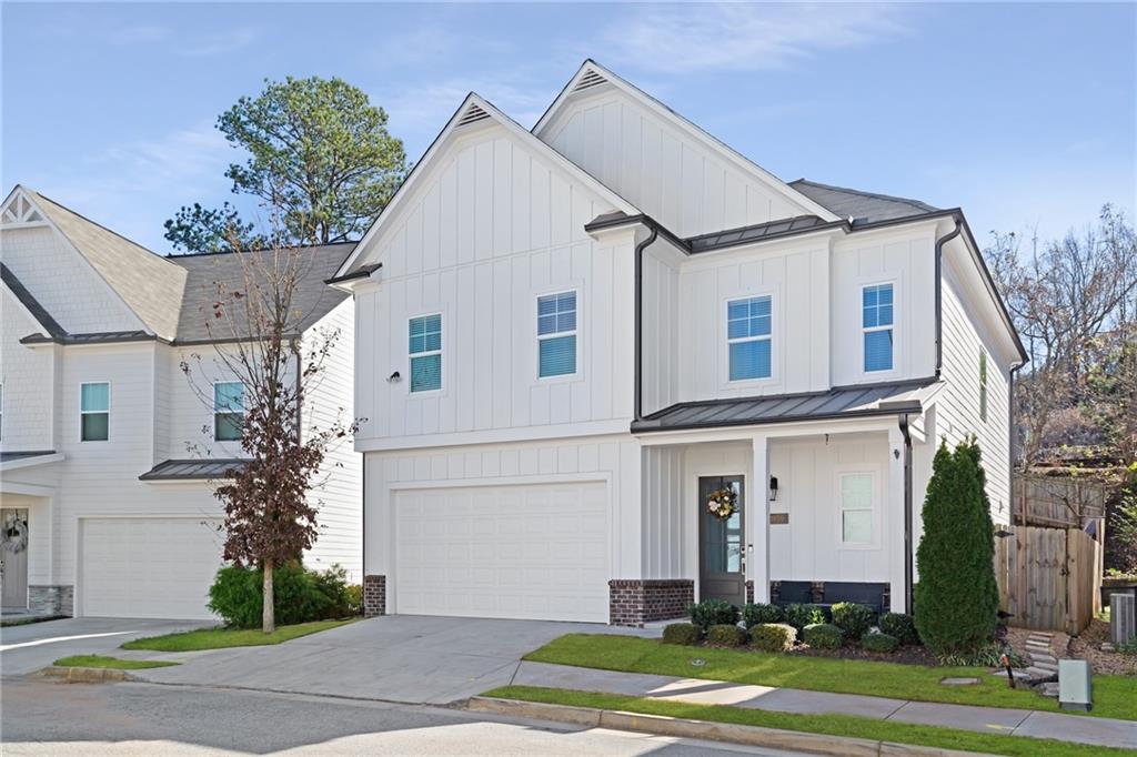 1859 Commons Place Atlanta, GA 30318 - Photo 51 of 53 a view of a white house with a yard and plants