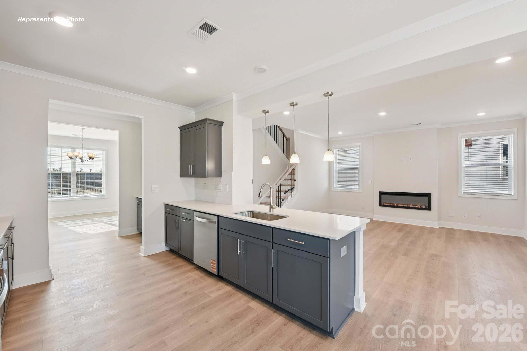 8905 Overhill Road Huntersville, NC 28078 - Photo 13 of 30 a large kitchen with stainless steel appliances kitchen island a large counter top and a sink
