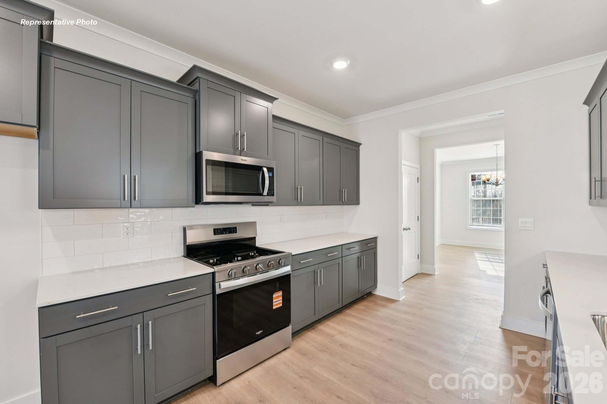8905 Overhill Road Huntersville, NC 28078 - Photo 14 of 30 a kitchen with granite countertop a sink and steel appliances