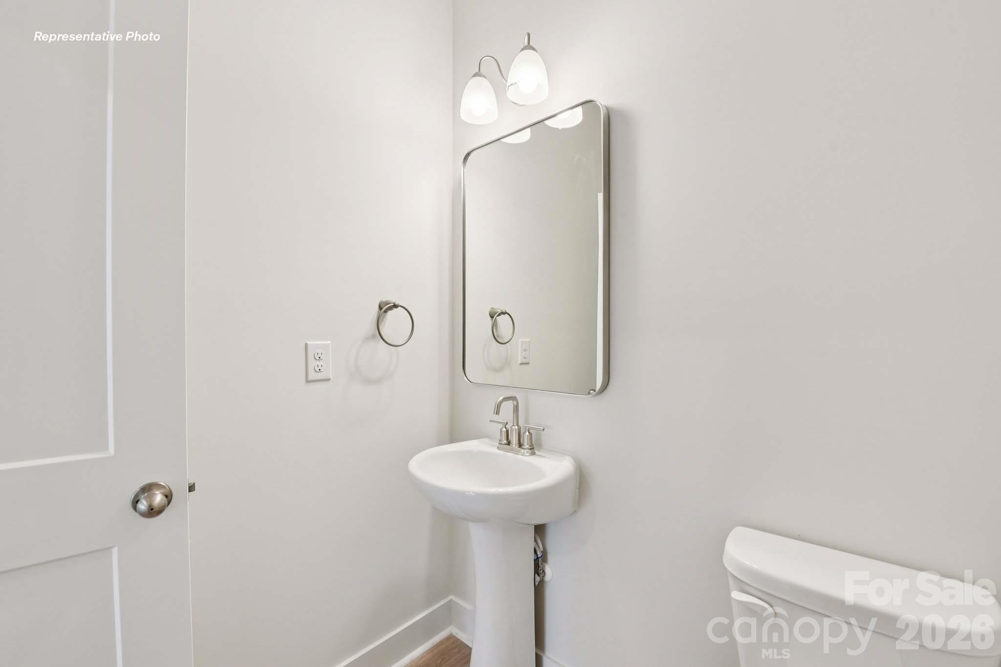 8905 Overhill Road Huntersville, NC 28078 - Photo 15 of 30 a bathroom with a sink a light fixture and a mirror
