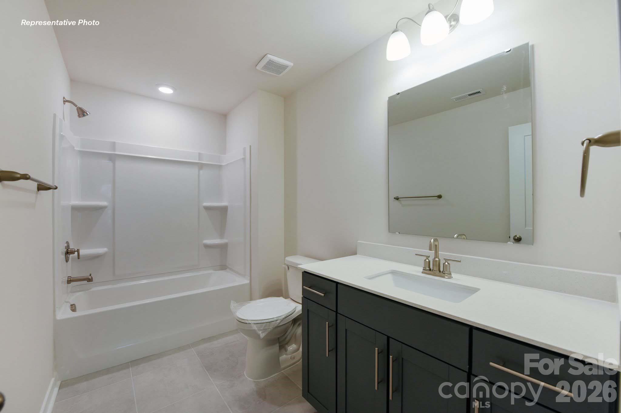 8905 Overhill Road Huntersville, NC 28078 - Photo 24 of 30 a bathroom with a sink a toilet and shower