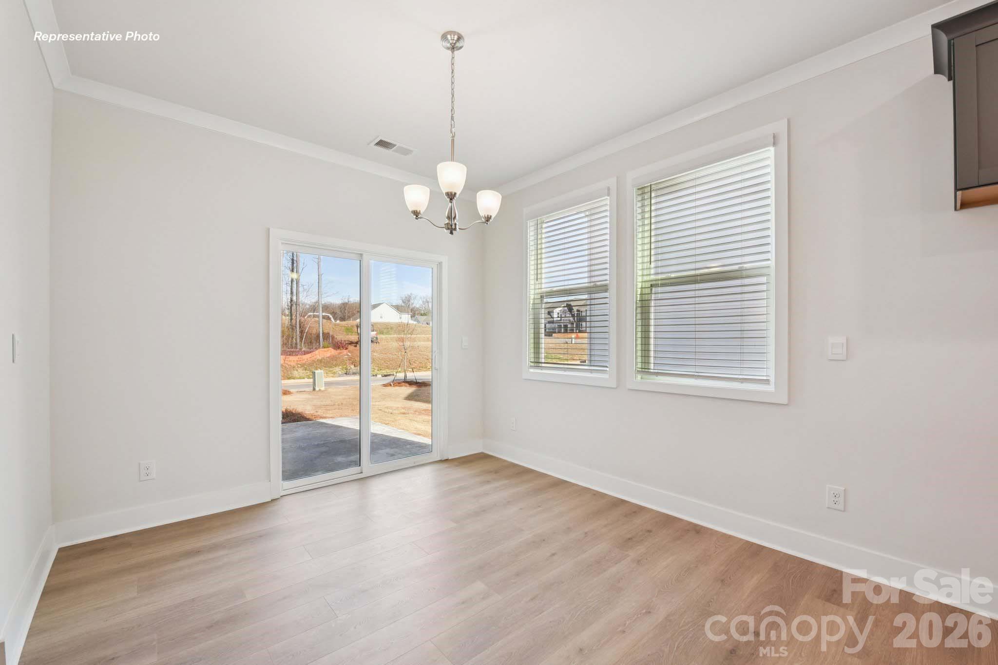 8905 Overhill Road Huntersville, NC 28078 - Photo 6 of 30 a view of a livingroom with a chandelier fan and windows