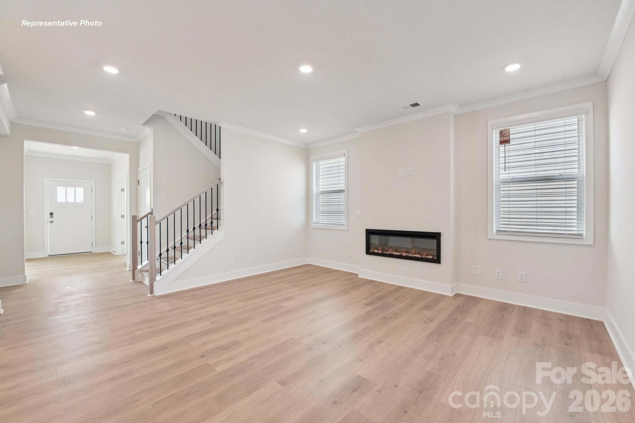 8905 Overhill Road Huntersville, NC 28078 - Photo 7 of 30 an empty room with wooden floor and windows