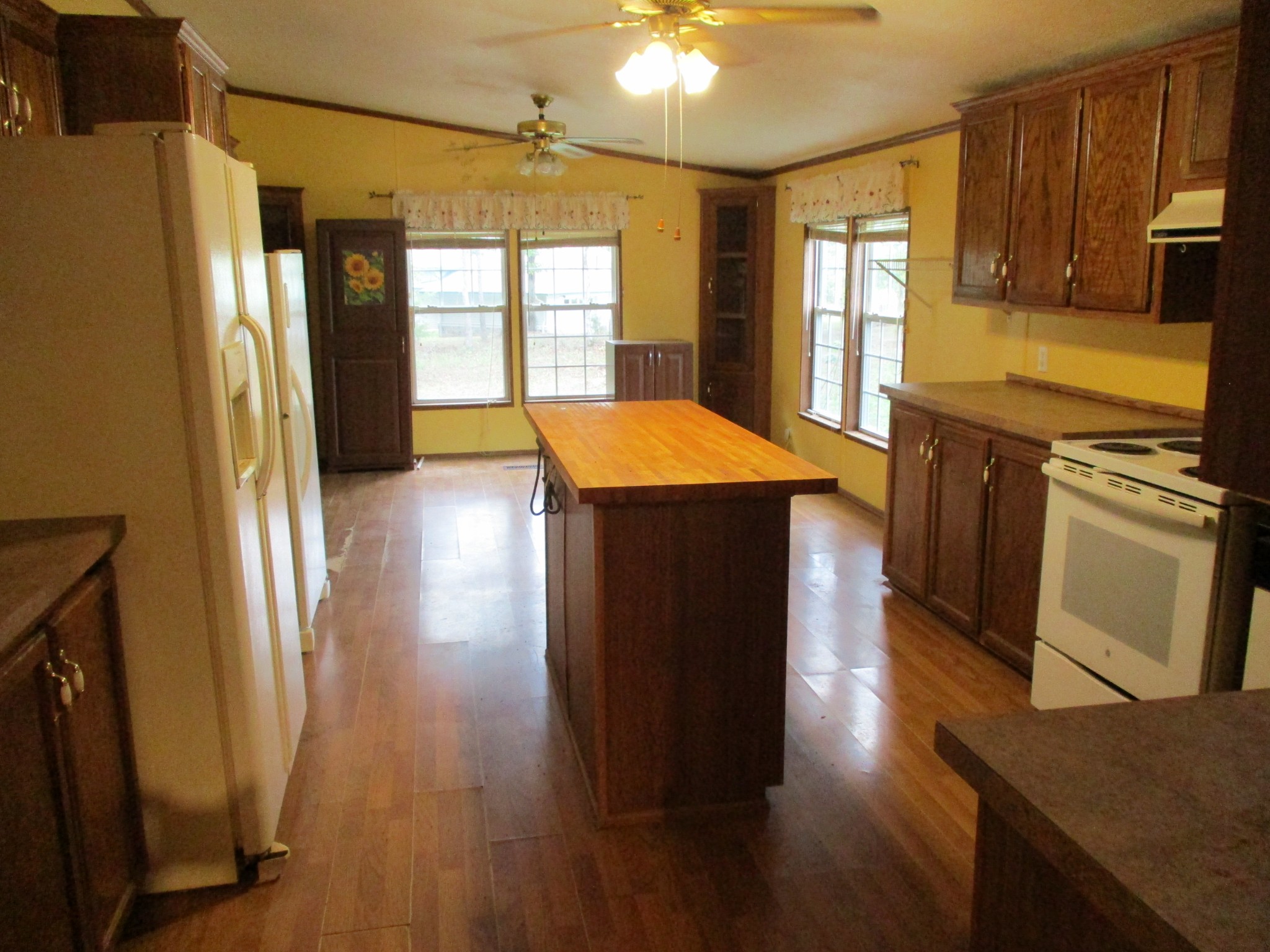 1112 Lecomte Road Dickson, TN 37055 - Photo 14 of 33 a kitchen with stainless steel appliances granite countertop a refrigerator a sink dishwasher a stove and white countertops with wooden floor