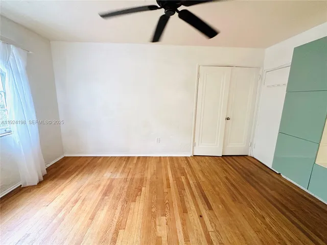 a view of an empty room and wooden floor