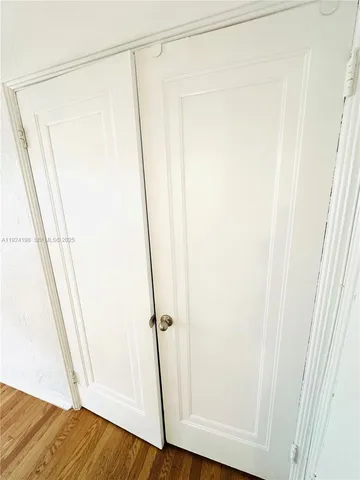 a view of walk in closet with wooden floor