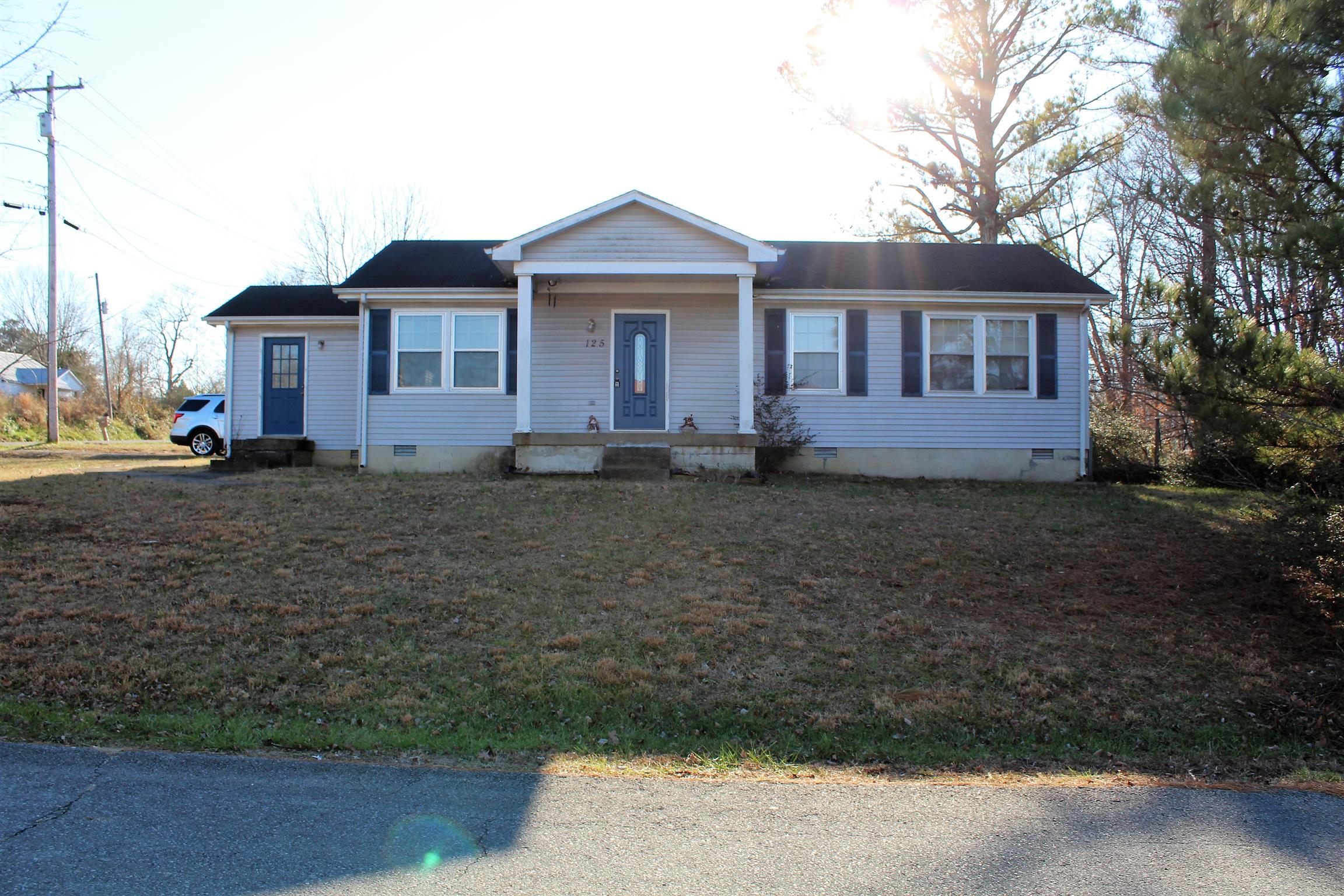 125 Jones Creek Road Dickson, TN 37055 - Photo 1 of 16 a view of a yard in front of a house with large trees