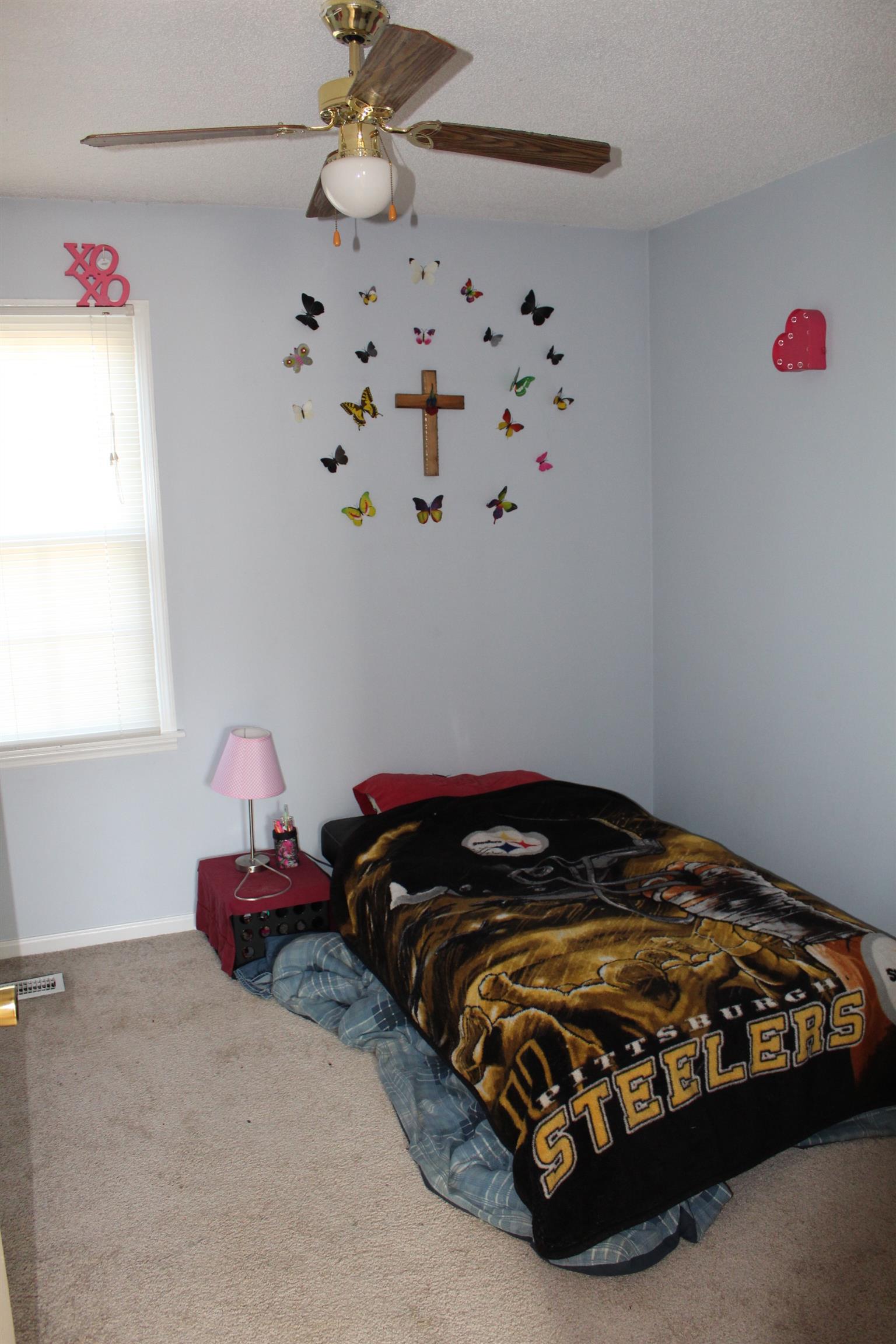 125 Jones Creek Road Dickson, TN 37055 - Photo 13 of 16 a bedroom with a bed and a chandelier