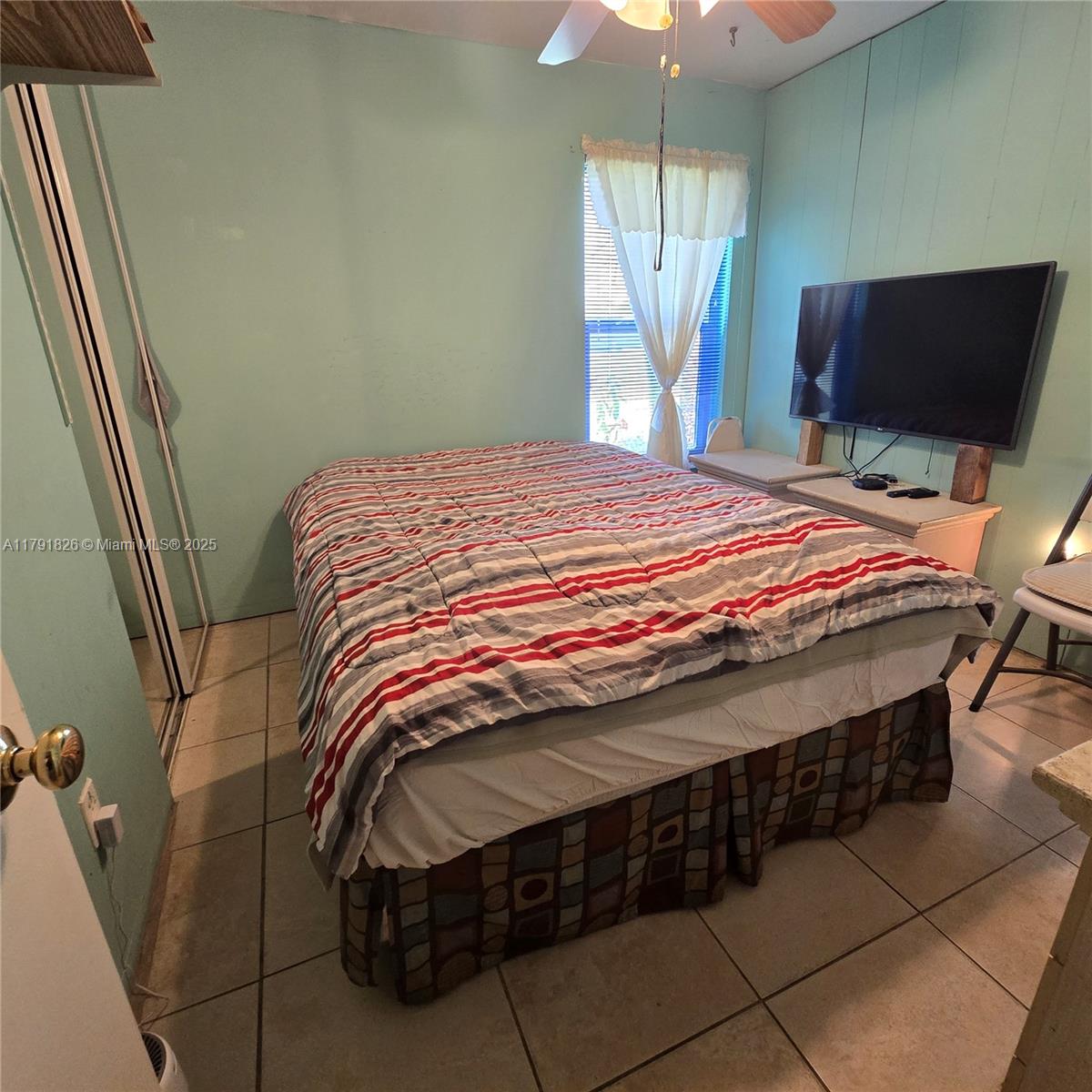 12900 Southwest 81st Street Miami, FL 33183 - Photo 12 of 19 a bedroom with a bed and a flat screen tv