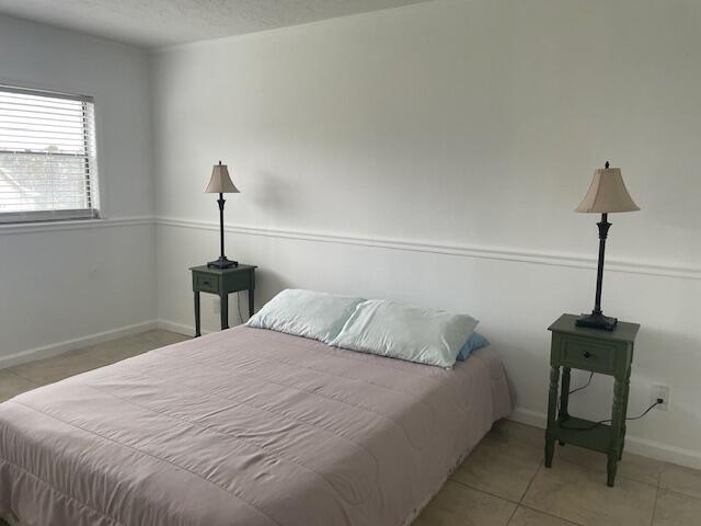 315 Tangle Run Boulevard, Unit 1023 Melbourne, FL 32940 - Photo 11 of 17 a bedroom with a bed and a window