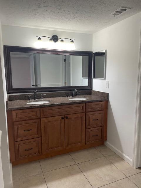 315 Tangle Run Boulevard, Unit 1023 Melbourne, FL 32940 - Photo 12 of 17 a spacious bathroom with a granite countertop sink and mirror