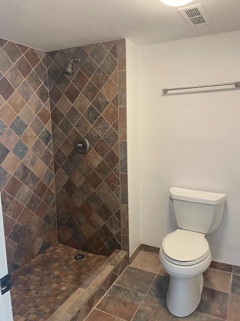 315 Tangle Run Boulevard, Unit 1023 Melbourne, FL 32940 - Photo 13 of 17 a white toilet sitting next to a shower