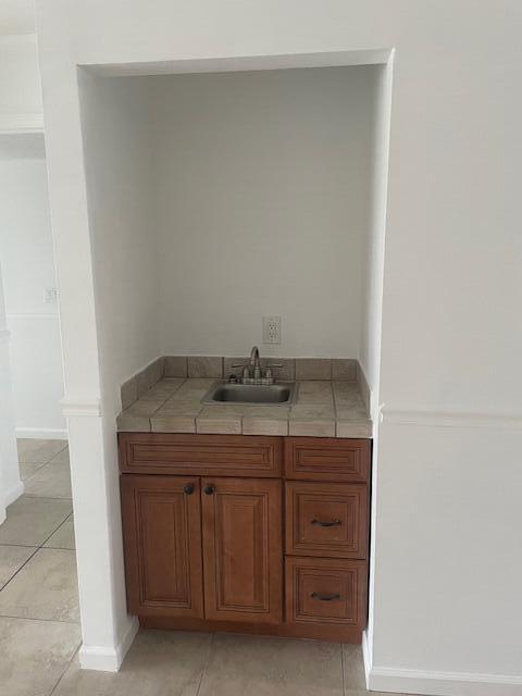 315 Tangle Run Boulevard, Unit 1023 Melbourne, FL 32940 - Photo 14 of 17 a bathroom with a granite countertop sink and vanity
