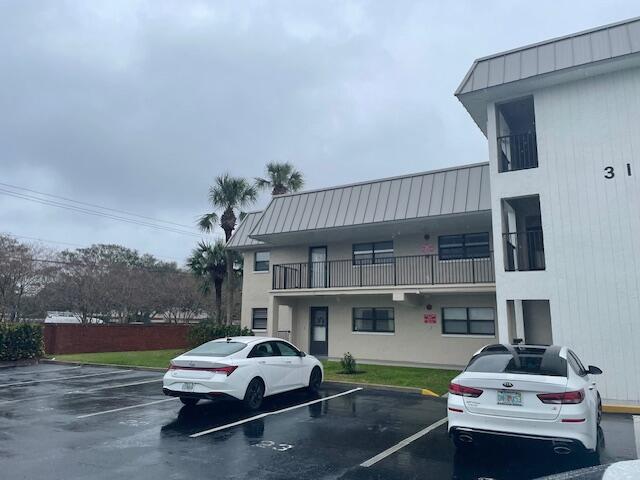 315 Tangle Run Boulevard, Unit 1023 Melbourne, FL 32940 - Photo 16 of 17 a car parked in front of a house
