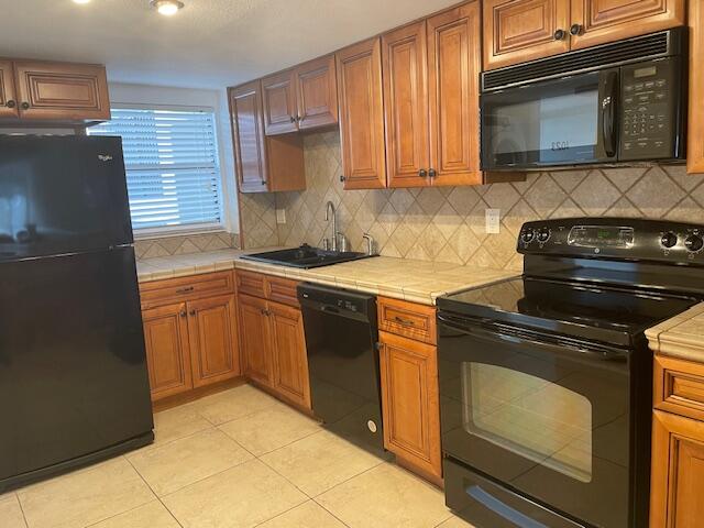 315 Tangle Run Boulevard, Unit 1023 Melbourne, FL 32940 - Photo 2 of 17 a kitchen with a stove microwave and sink