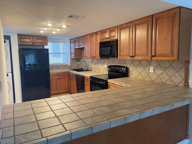 315 Tangle Run Boulevard, Unit 1023 Melbourne, FL 32940 - Photo 7 of 17 a kitchen with stainless steel appliances kitchen island granite countertop a refrigerator and a sink