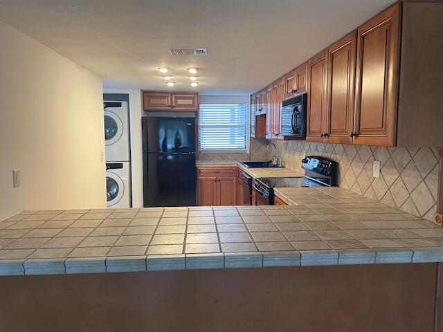 315 Tangle Run Boulevard, Unit 1023 Melbourne, FL 32940 - Photo 8 of 17 a kitchen with granite countertop stainless steel appliances and wooden cabinets