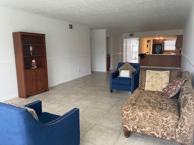 315 Tangle Run Boulevard, Unit 1023 Melbourne, FL 32940 - Photo 9 of 17 a living room with furniture and a flat screen tv
