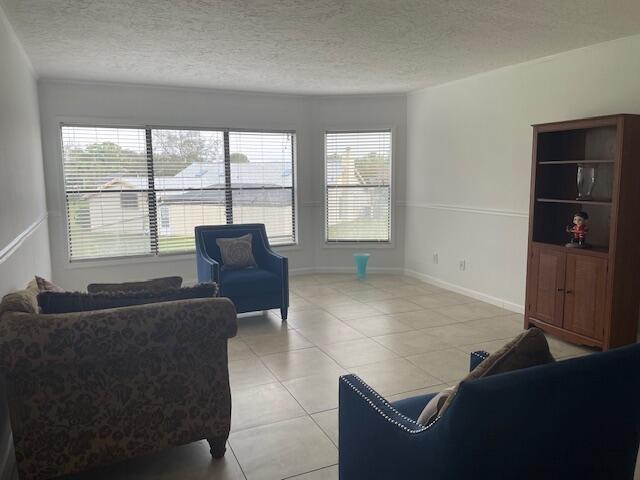 315 Tangle Run Boulevard, Unit 1023 Melbourne, FL 32940 - Photo 10 of 17 a living room with furniture and large windows